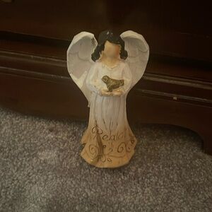 Angel that says peace on the bottom of her dress